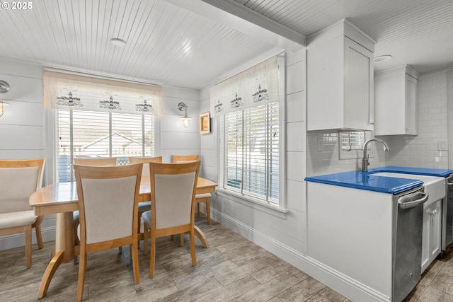 dining space with light wood finished floors, baseboards, and a wealth of natural light