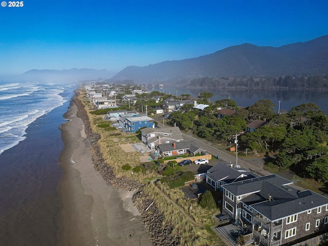 aerial view featuring a water and mountain view and a beach view