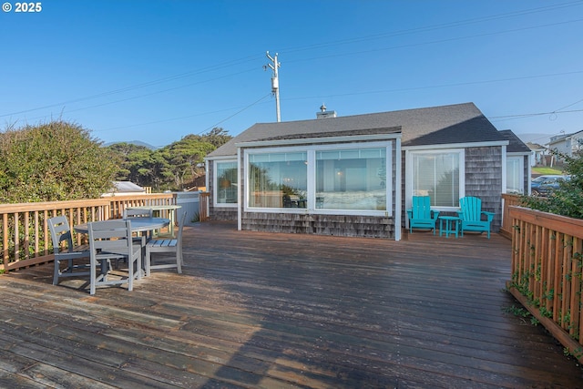 wooden terrace with outdoor dining space