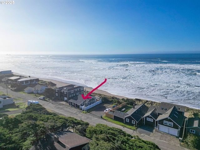 bird's eye view with a water view, a beach view, and a residential view