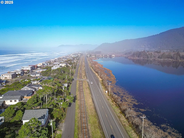 birds eye view of property with a water and mountain view