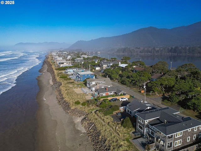 aerial view with a view of the beach and a water and mountain view