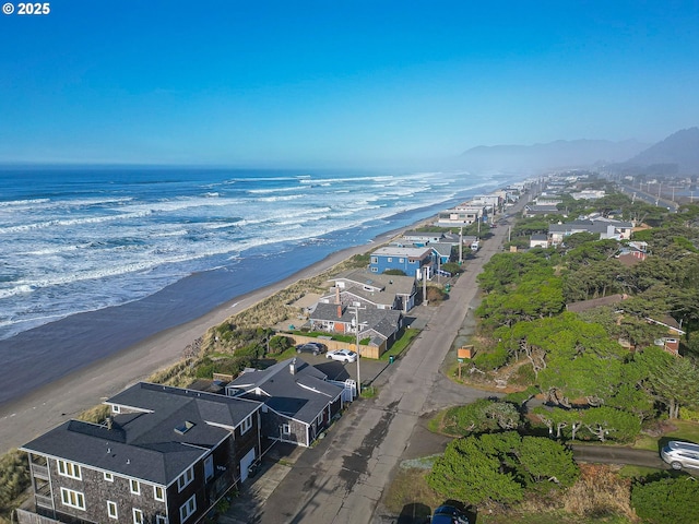 bird's eye view with a water view and a beach view