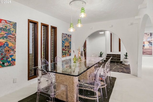 dining room with arched walkways