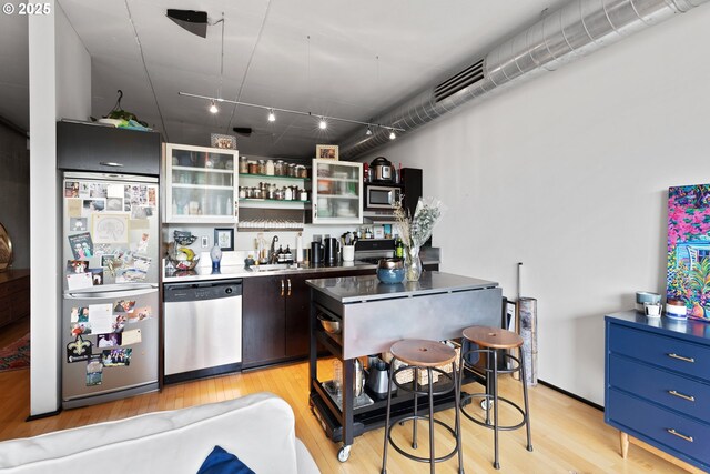 1410 NW Kearney St Unit 614, Portland, OR 97209 - indoor wet bar with stainless steel appliances and light wood-type flooring