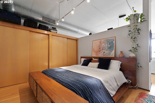 1410 NW Kearney St Unit 614, Portland, OR 97209 - bedroom with wood finished floors and track lighting