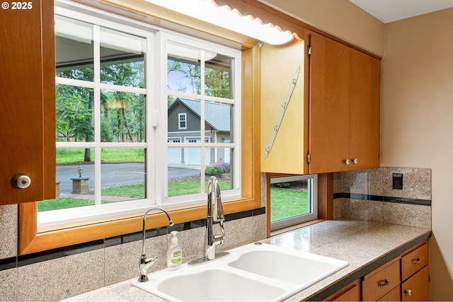 7678 Pine Tree Ln SE, Turner, OR 97392 - kitchen with a sink, backsplash, and brown cabinetry