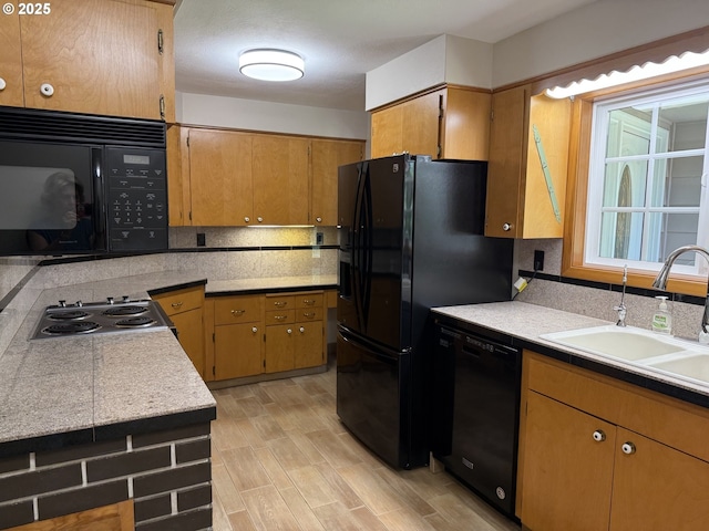 7678 Pine Tree Ln SE, Turner, OR 97392 - kitchen featuring black appliances, a sink, backsplash, light countertops, and light wood-style flooring