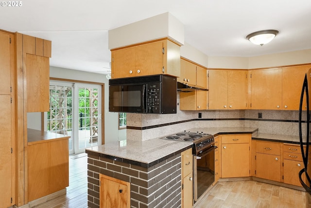 7678 Pine Tree Ln SE, Turner, OR 97392 - kitchen with black microwave, range with electric stovetop, tasteful backsplash, light wood-style floors, and under cabinet range hood