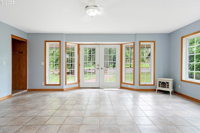 7678 Pine Tree Ln SE, Turner, OR 97392 - doorway to outside featuring a wood stove, baseboards, french doors, and light tile patterned flooring
