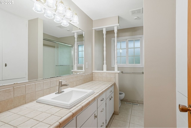 7678 Pine Tree Ln SE, Turner, OR 97392 - full bathroom featuring toilet, vanity, tile patterned flooring, and healthy amount of natural light