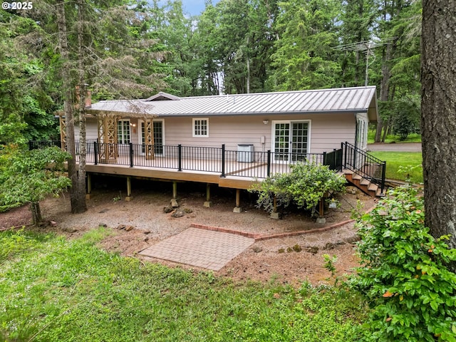 7678 Pine Tree Ln SE, Turner, OR 97392 - back of property with a deck, metal roof, a standing seam roof, and stairway