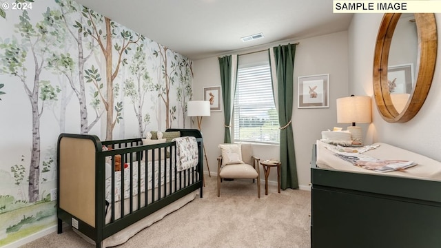 bedroom featuring a nursery area, carpet flooring, and visible vents