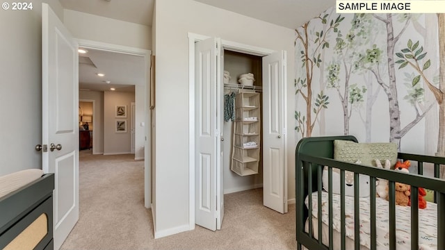 bedroom featuring recessed lighting, a closet, light carpet, and baseboards