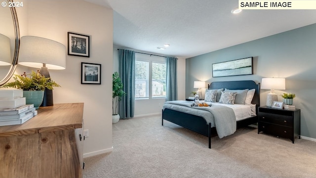 bedroom with a textured ceiling, carpet, visible vents, and baseboards