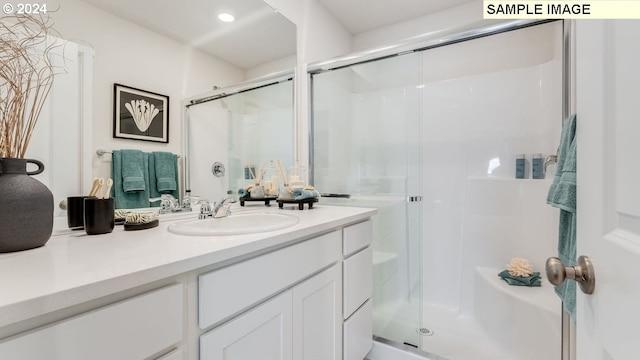 bathroom featuring a shower stall, vanity, and recessed lighting