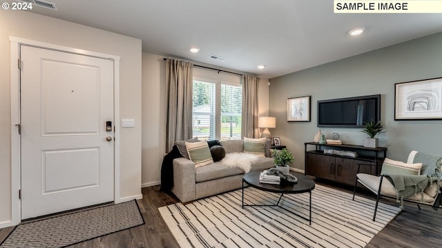 living area with recessed lighting, visible vents, baseboards, and wood finished floors