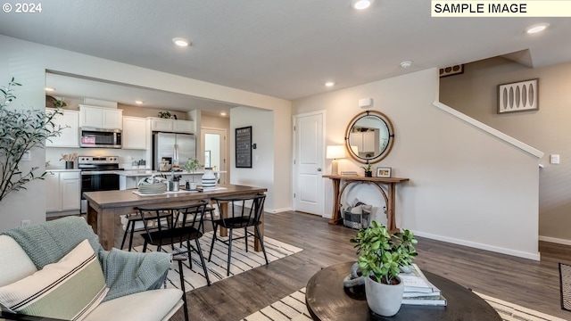 living area featuring dark wood-style floors, stairway, baseboards, and recessed lighting