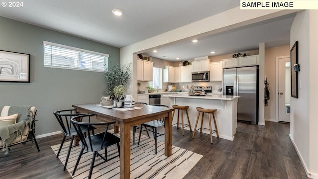 dining area with recessed lighting, dark wood finished floors, and baseboards