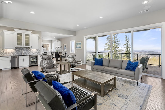 living area with wine cooler, visible vents, recessed lighting, and wet bar