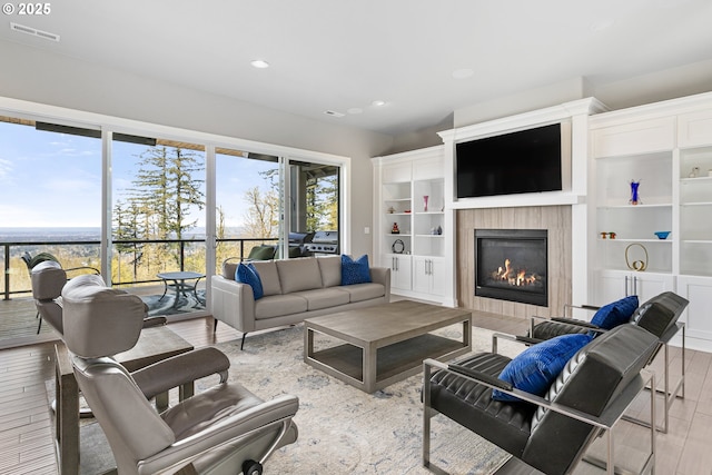 10397 SE Quail Ridge Dr, Happy Valley, OR 97086 - living room with wood finished floors, a fireplace, and recessed lighting