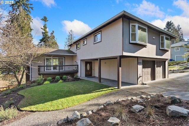 view of front facade with a garage, a deck, and a front lawn