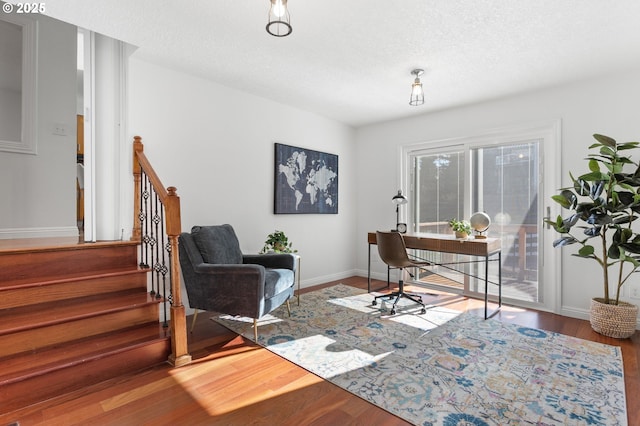 home office featuring hardwood / wood-style floors and a textured ceiling