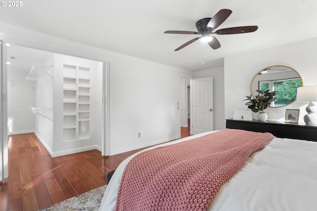 bedroom featuring ceiling fan, dark wood-type flooring, and a textured ceiling