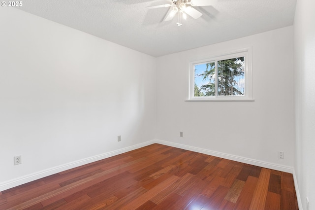 spare room featuring hardwood / wood-style flooring and a textured ceiling