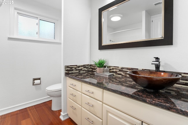 bathroom with vanity, wood-type flooring, walk in shower, and toilet