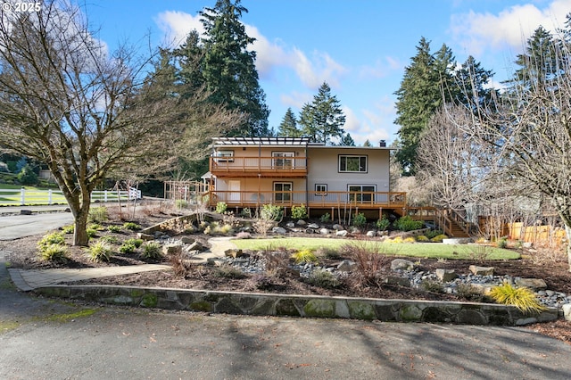 back of property featuring a wooden deck