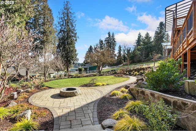 view of yard featuring an outdoor fire pit and a patio area