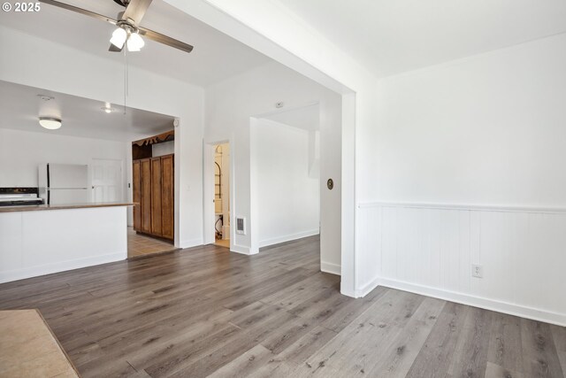 400 Mccoy St, Moro, OR 97039 - unfurnished living room featuring ceiling fan, visible vents, wainscoting, and wood finished floors