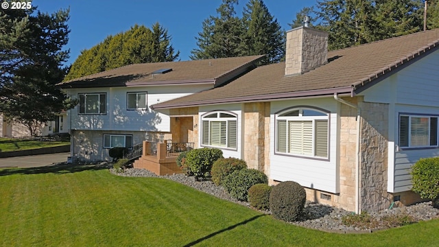 back of house with a lawn