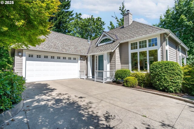 9614 NW Durrett St, Portland, OR 97229 - view of front of property featuring driveway, a chimney, an attached garage, and roof with shingles