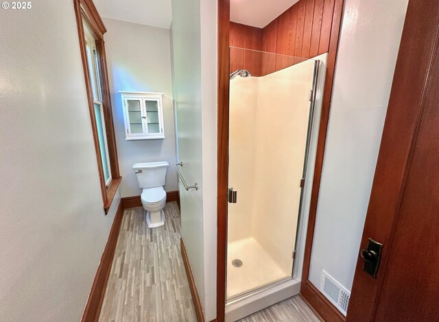 812 SW Saint Clair Ave Unit 3, Portland, OR 97205 - bathroom featuring a shower stall, wood finished floors, baseboards, and toilet