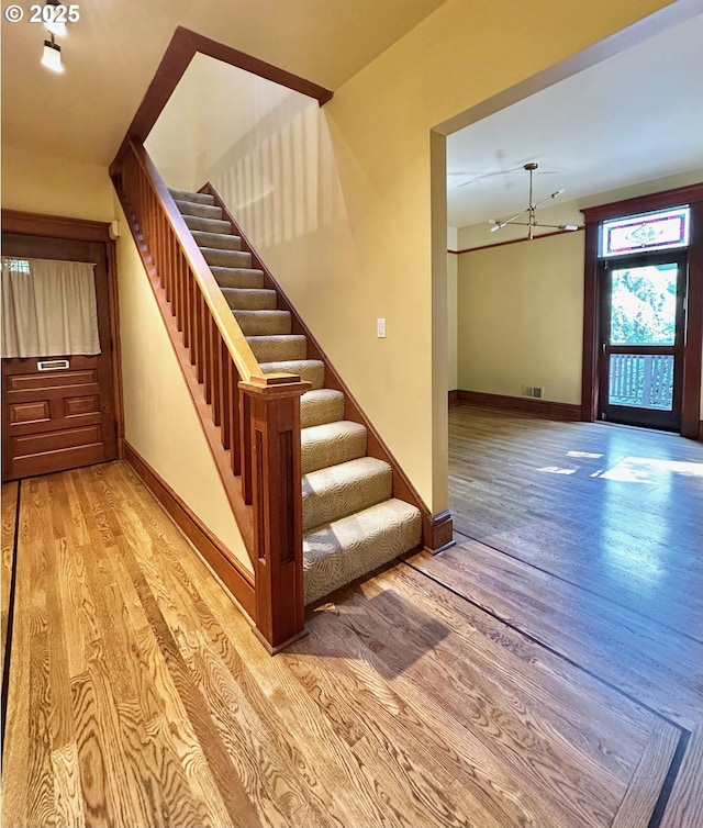 812 SW Saint Clair Ave Unit 3, Portland, OR 97205 - staircase featuring wood finished floors and baseboards