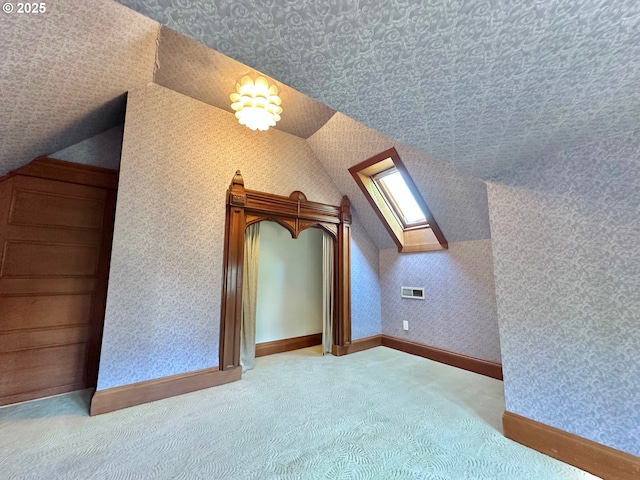 812 SW Saint Clair Ave Unit 3, Portland, OR 97205 - bonus room featuring carpet flooring, lofted ceiling, a skylight, and baseboards