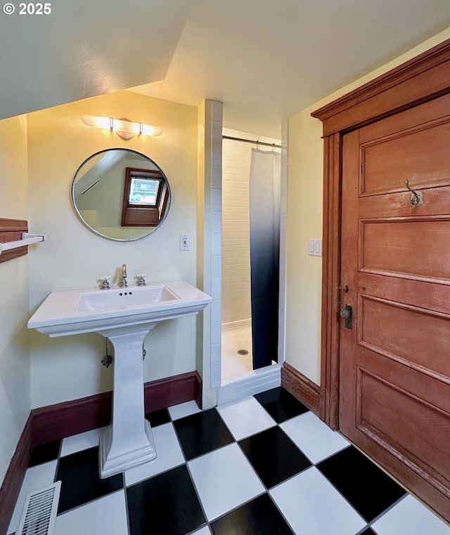 812 SW Saint Clair Ave Unit 3, Portland, OR 97205 - bathroom with tile patterned floors, a shower stall, and baseboards
