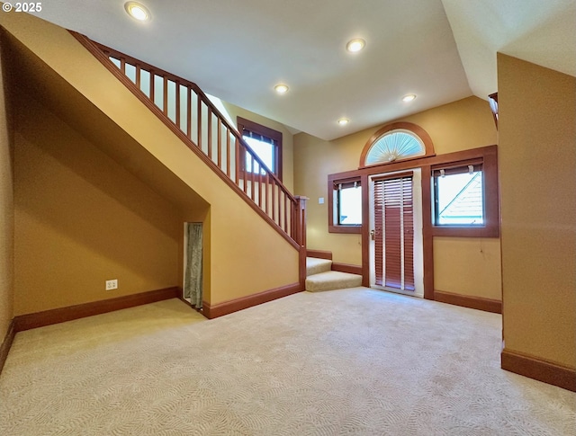 812 SW Saint Clair Ave Unit 3, Portland, OR 97205 - entrance foyer featuring light carpet, stairs, baseboards, recessed lighting, and vaulted ceiling