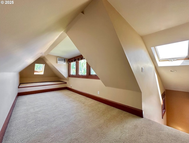 812 SW Saint Clair Ave Unit 3, Portland, OR 97205 - bonus room featuring a skylight, carpet, a wall unit AC, lofted ceiling, and baseboards