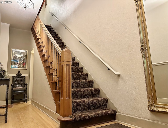 812 SW Saint Clair Ave Unit 3, Portland, OR 97205 - stairway featuring hardwood / wood-style flooring and baseboards