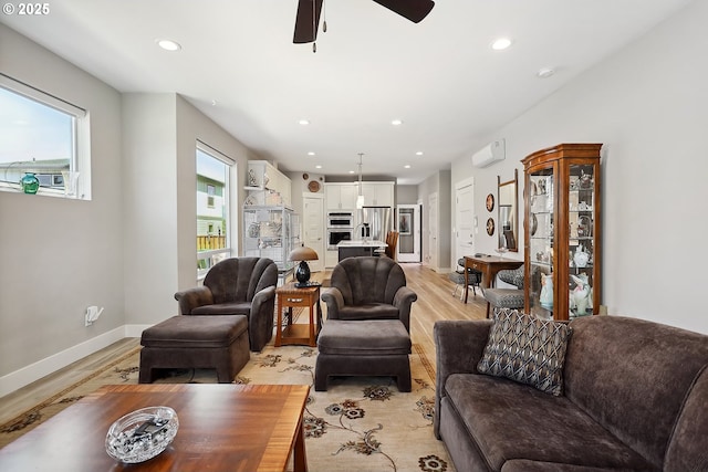 1250 29th St, Hood River, OR 97031 - living room with baseboards, a wall mounted air conditioner, ceiling fan, light wood-type flooring, and recessed lighting