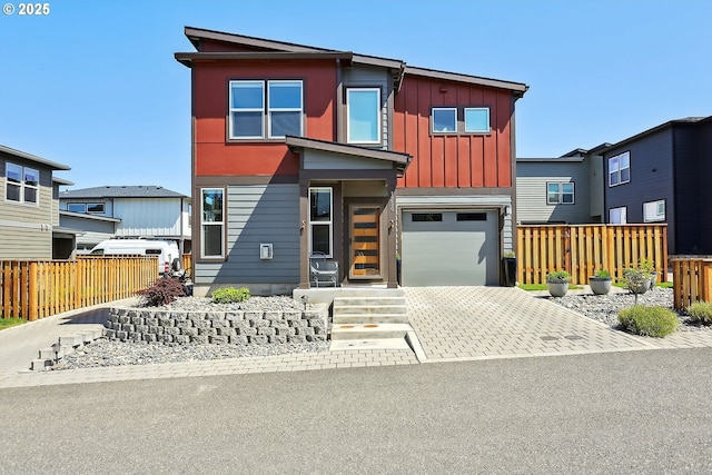 1250 29th St, Hood River, OR 97031 - contemporary house featuring a garage, board and batten siding, fence, and driveway
