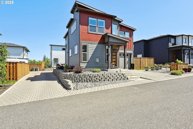 1250 29th St, Hood River, OR 97031 - contemporary home featuring board and batten siding, an attached garage, fence, and driveway