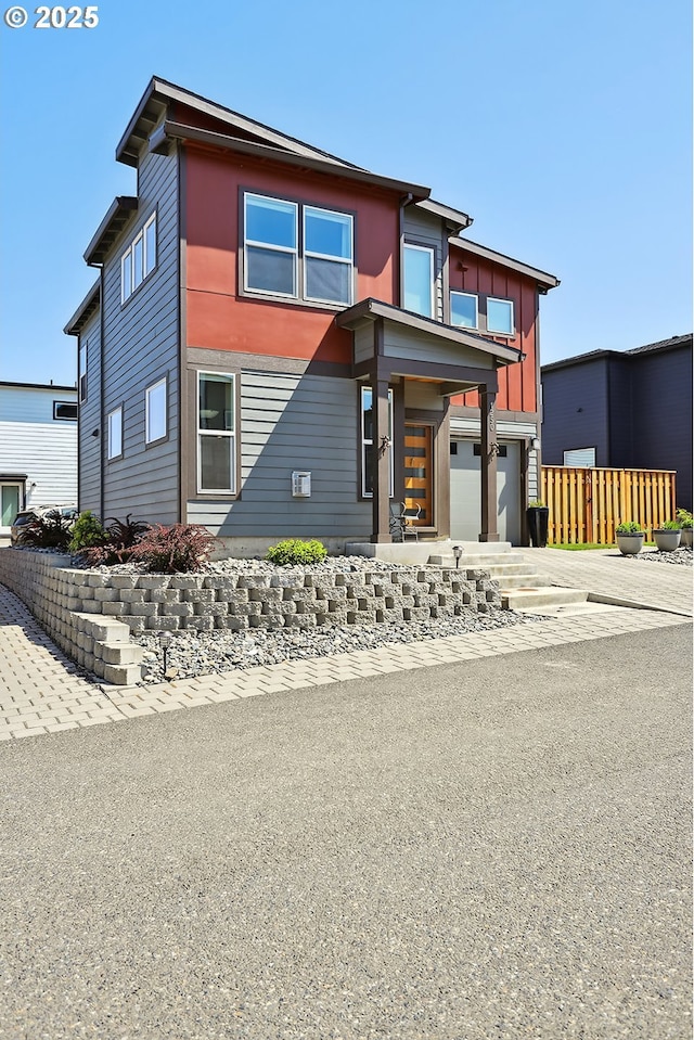 1250 29th St, Hood River, OR 97031 - contemporary house featuring fence, an attached garage, and driveway