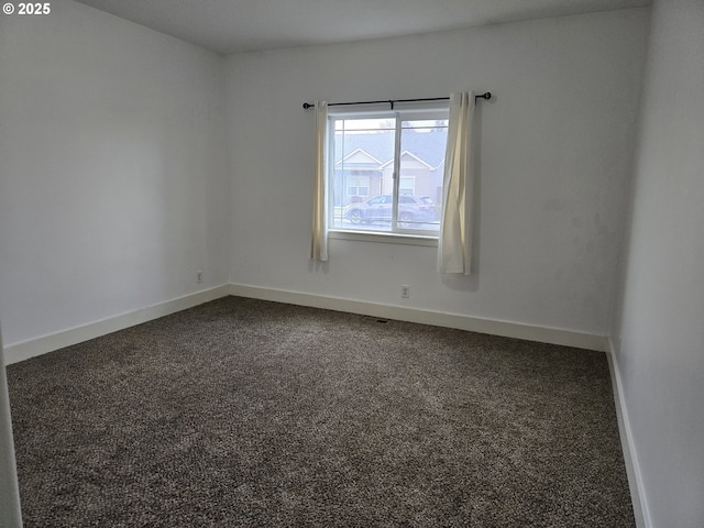 empty room featuring dark colored carpet