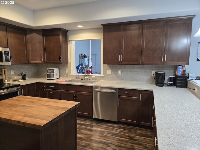 kitchen featuring dark hardwood / wood-style floors, stainless steel appliances, tasteful backsplash, wood counters, and sink