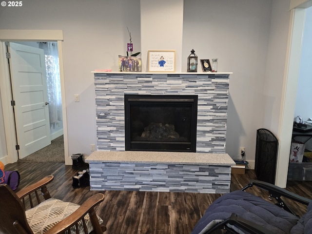 room details featuring a tile fireplace and hardwood / wood-style flooring