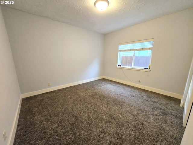 carpeted spare room with a textured ceiling